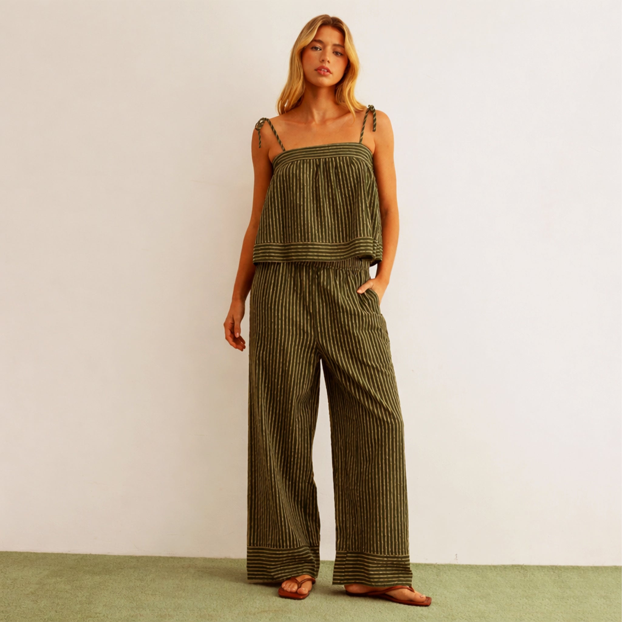 A pair of green and cream striped wide leg pants. 