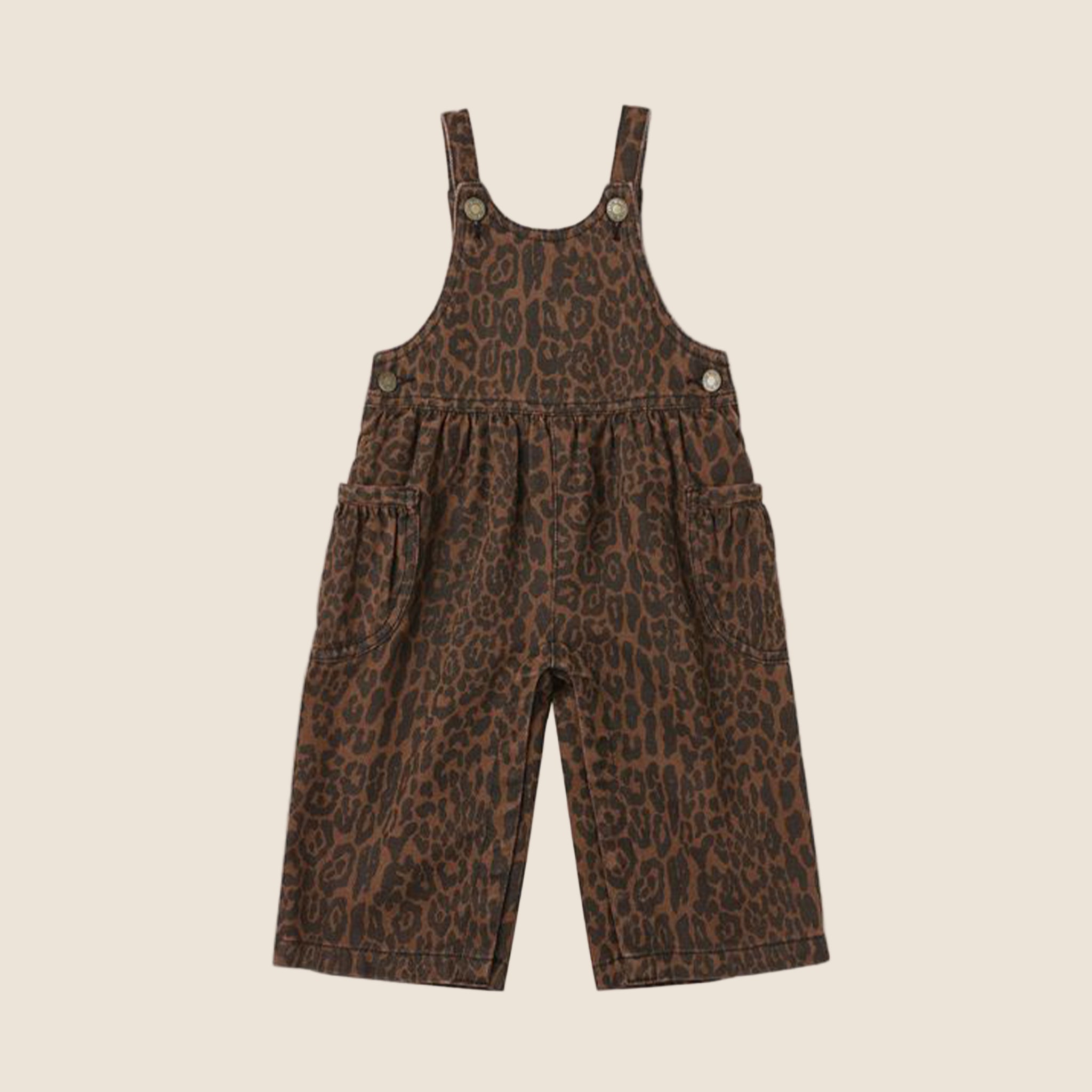 A pair of children's white leg brown leopard print overalls. 