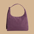 A plum purple colored nylon shoulder bag.