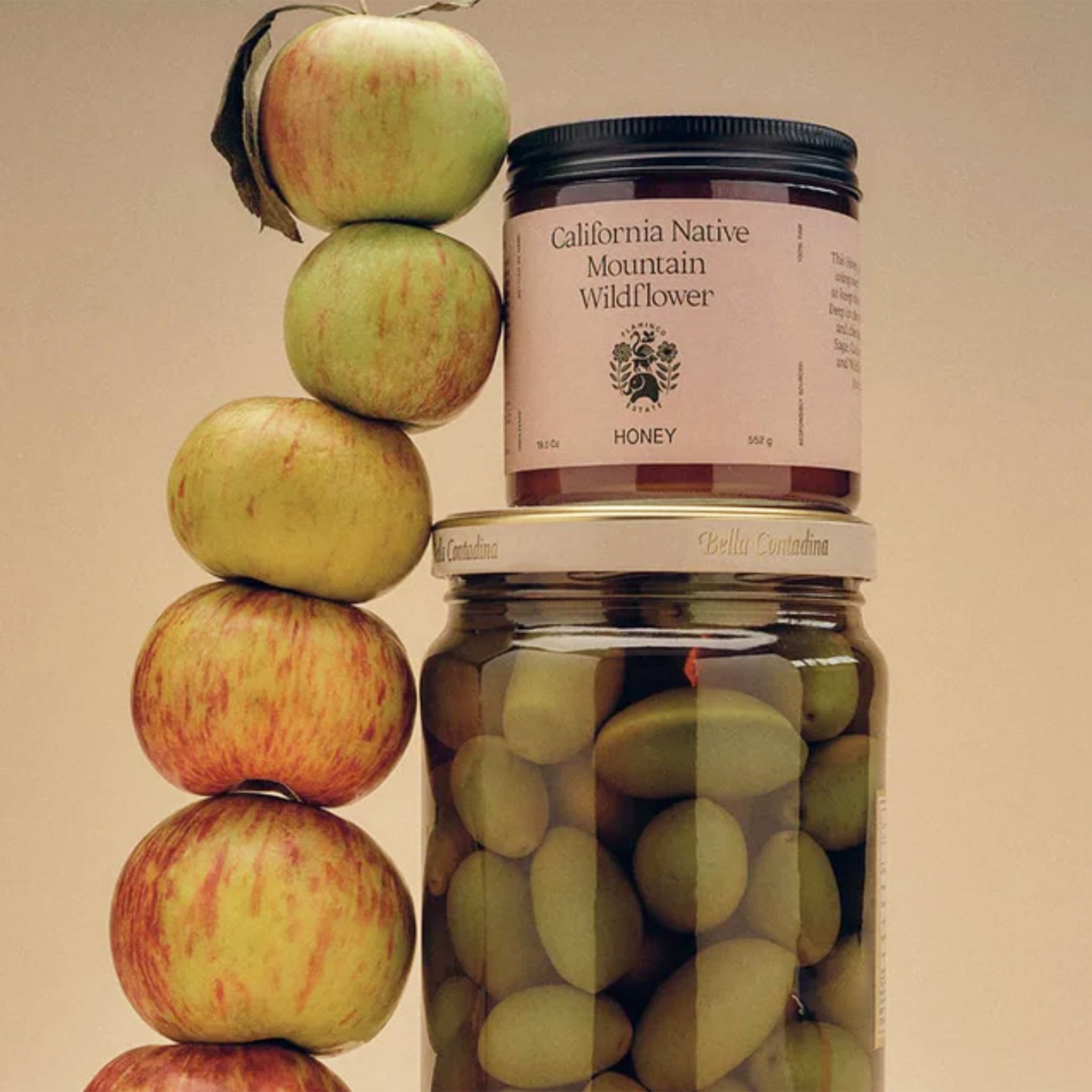 A glass jar of honey with a label that reads, "California Native Mountain Wildflower Honey". 