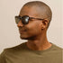 A pair of tortoise brown sunglasses with a square frame. 