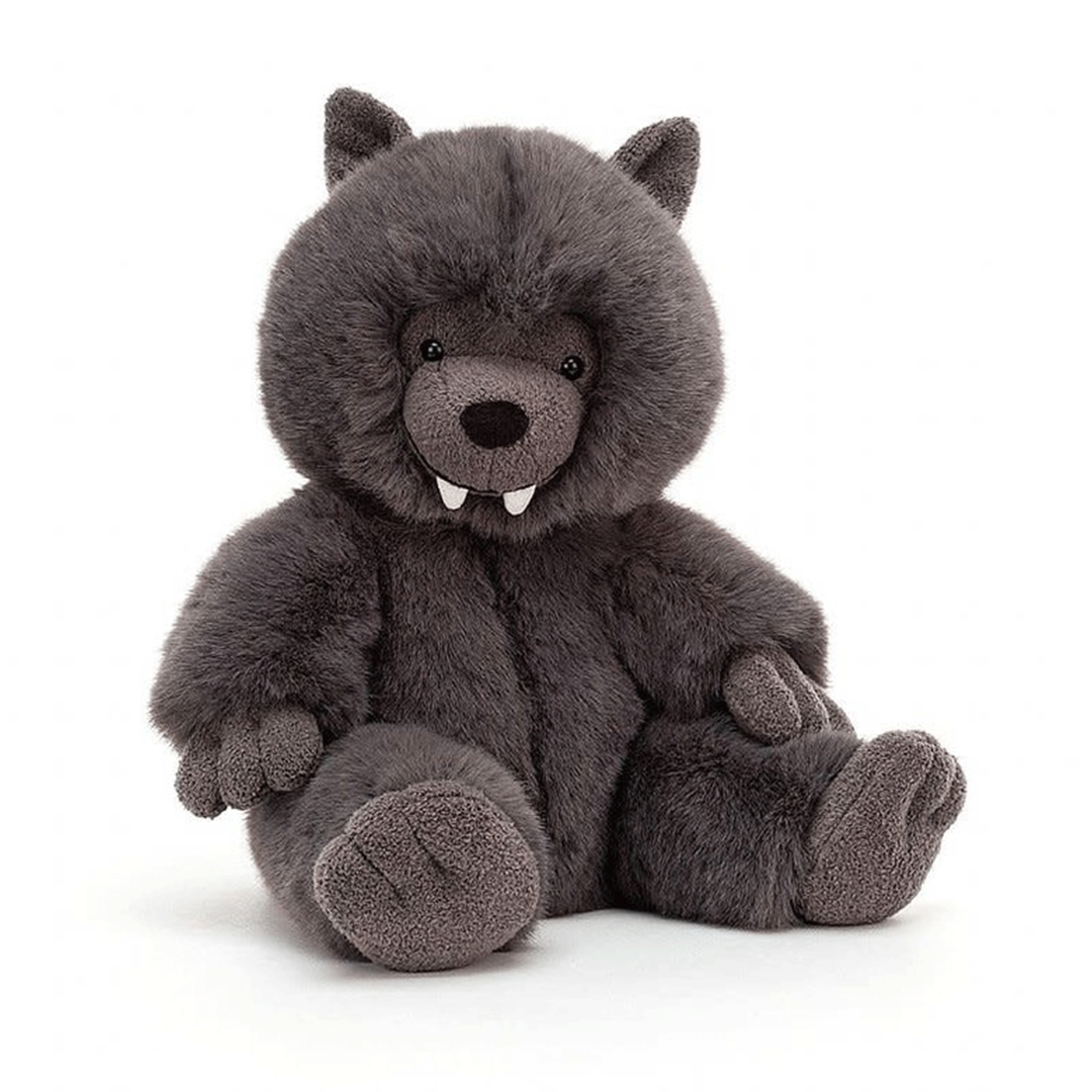 On a white background is a grey furry stuffed toy wolf with two front teeth. 