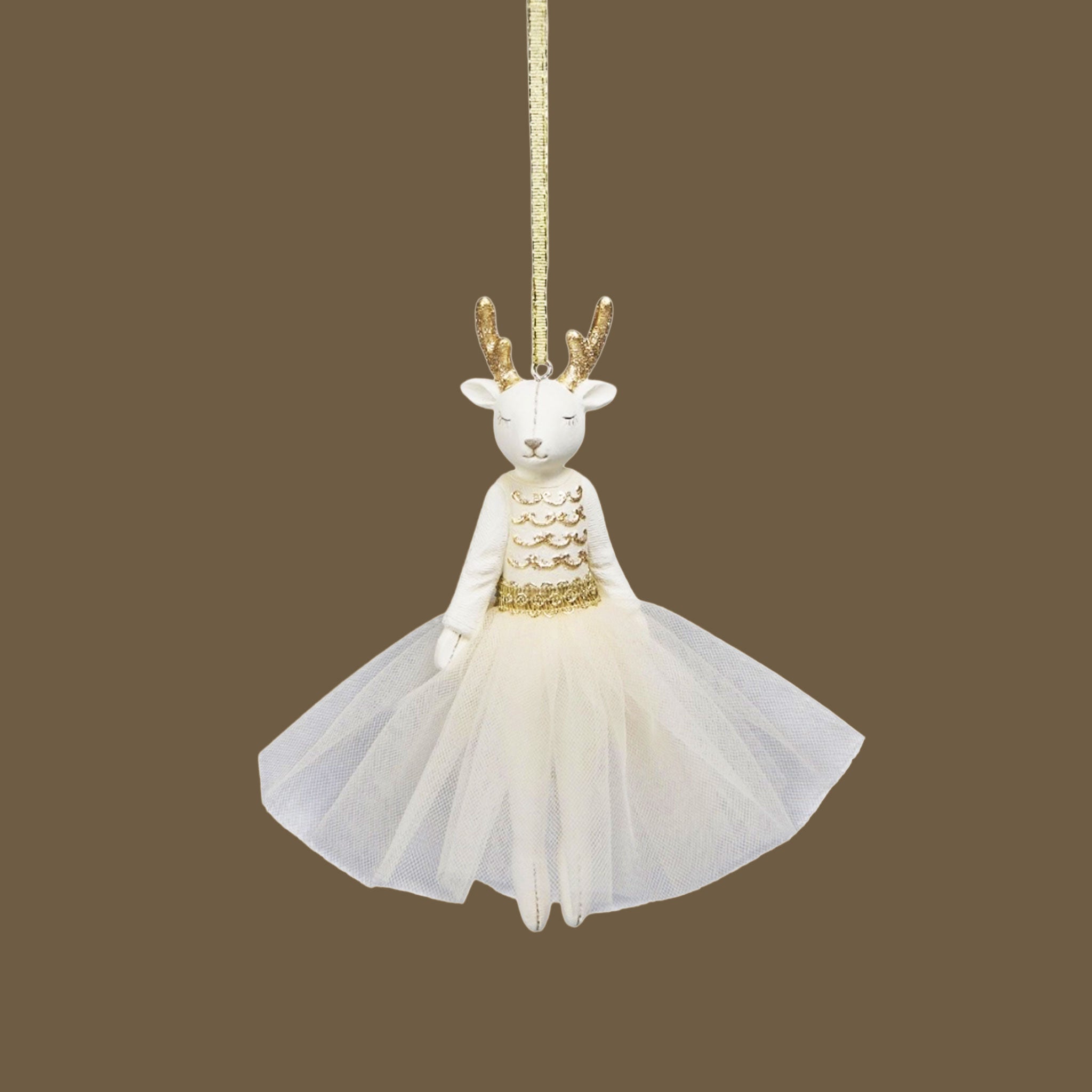 A white deer shaped ornament with a white tutu on a brown background.
