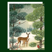 A greeting card with an illustration of two deer in a woodland backdrop. 
