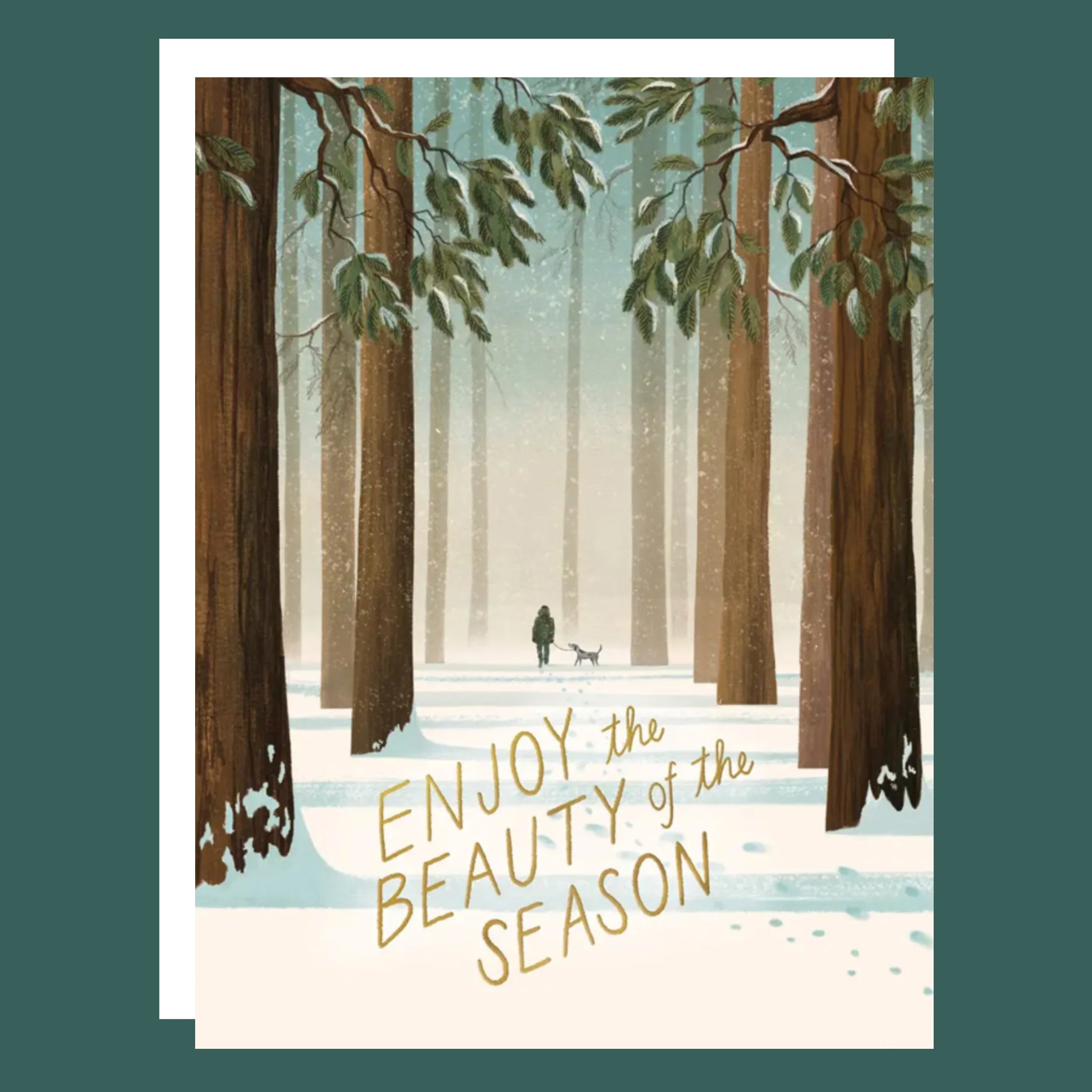 A card with an illustration of a forest and someone walking their dog along with text that reads, 'Enjoy the Beauty of the Season' and an inside message that reads, 'May your toes be warm and your heart be full'.