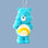 On a blue background is a blue care bear shaped glass ornament with a yellow shooting star on its stomach. 