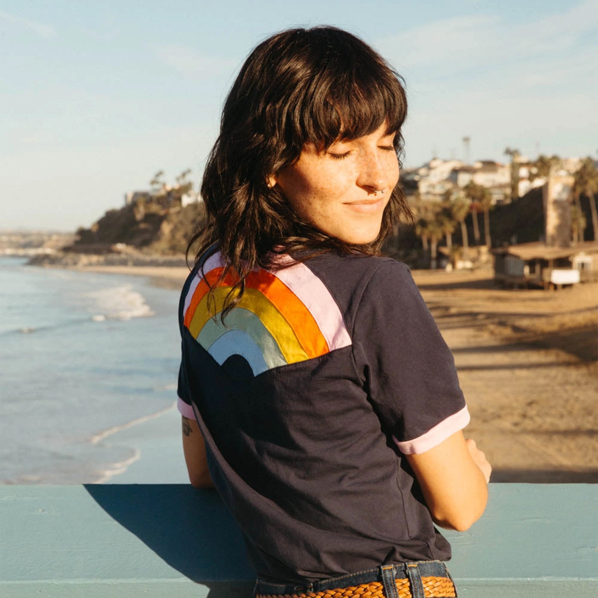 A ringer tee with a rainbow embroidery on the back. 