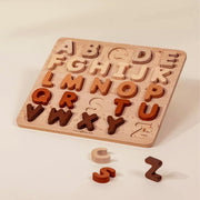 A wooden neutral alphabet puzzle toy. 