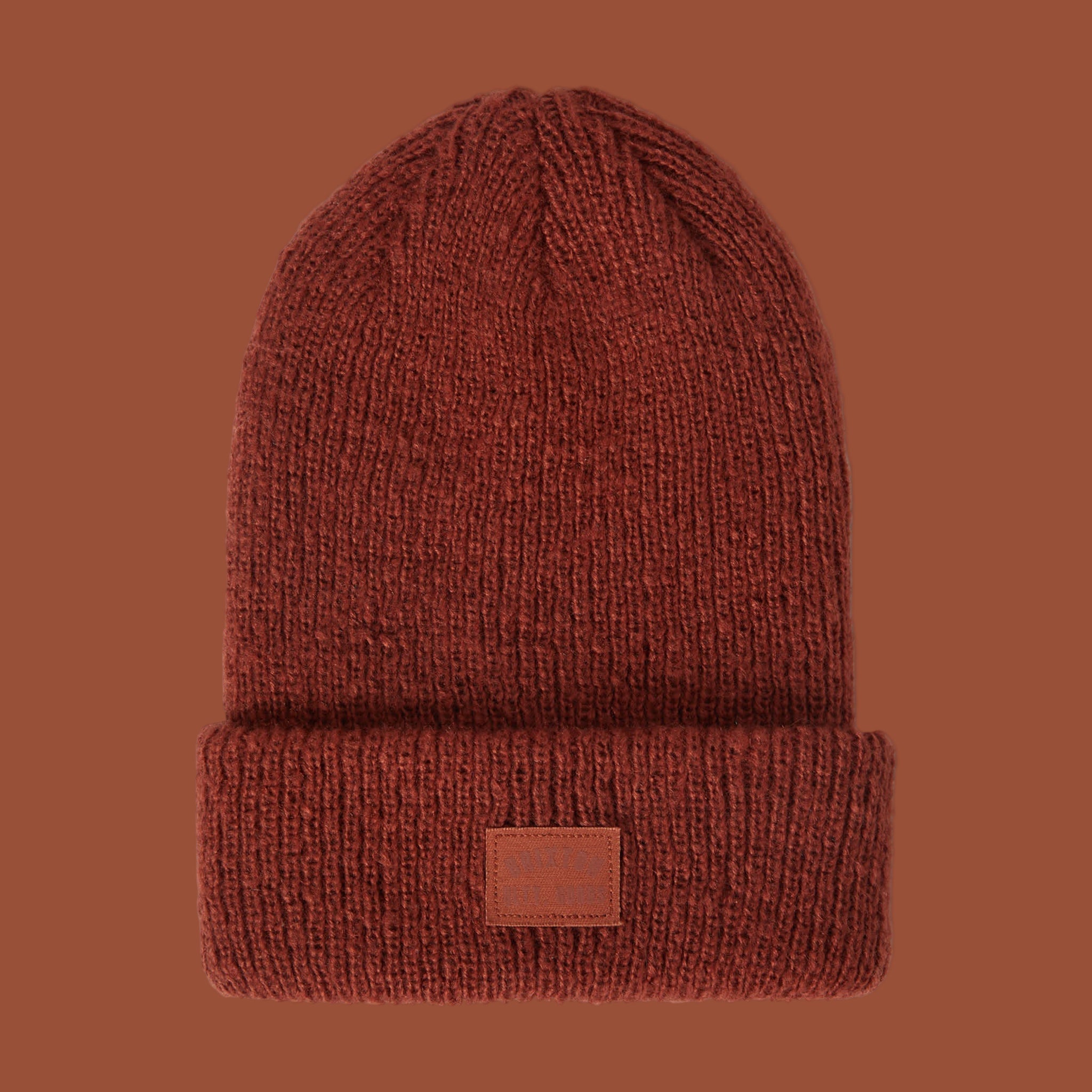 A reddish knit beanie. 