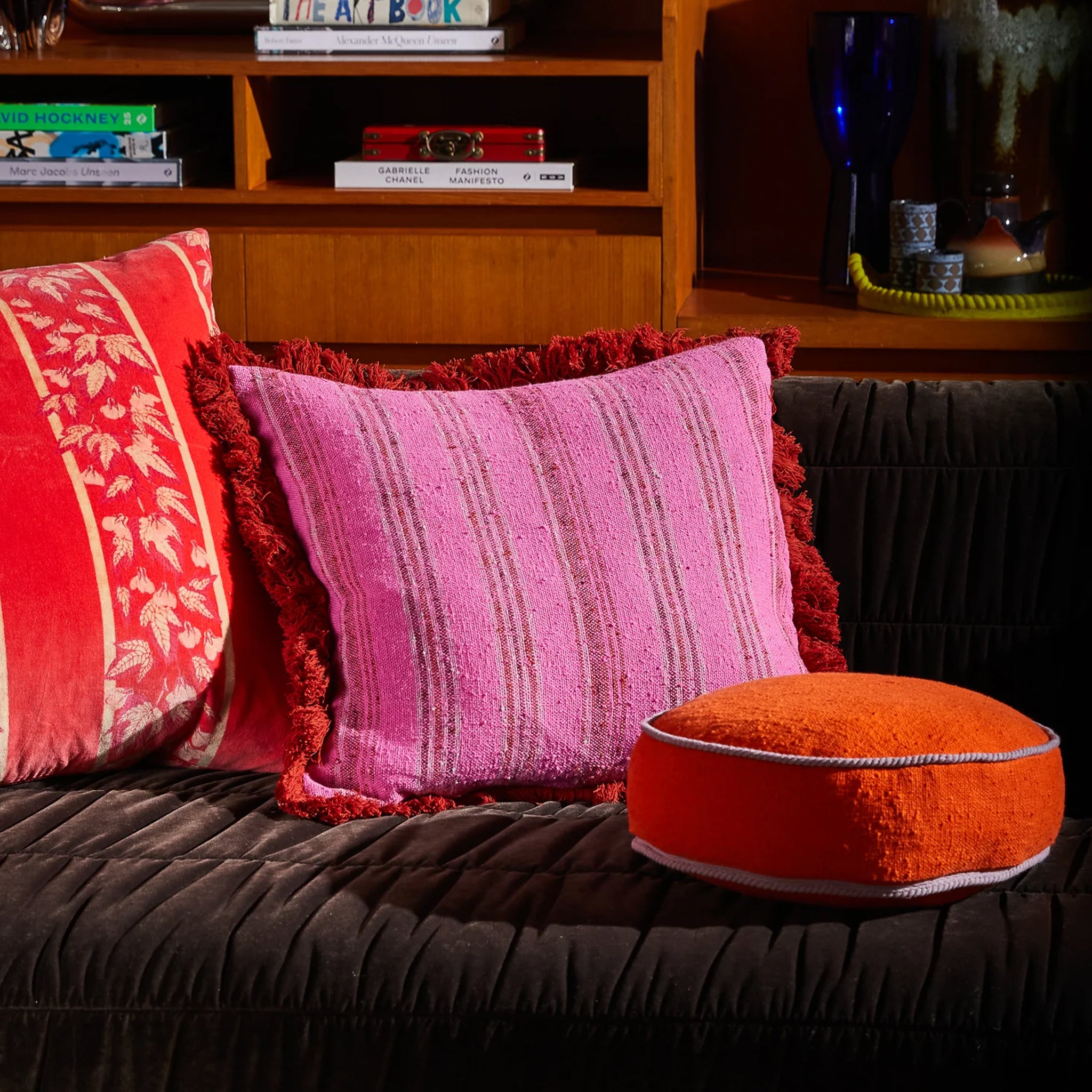 A pink and red striped pillow. 