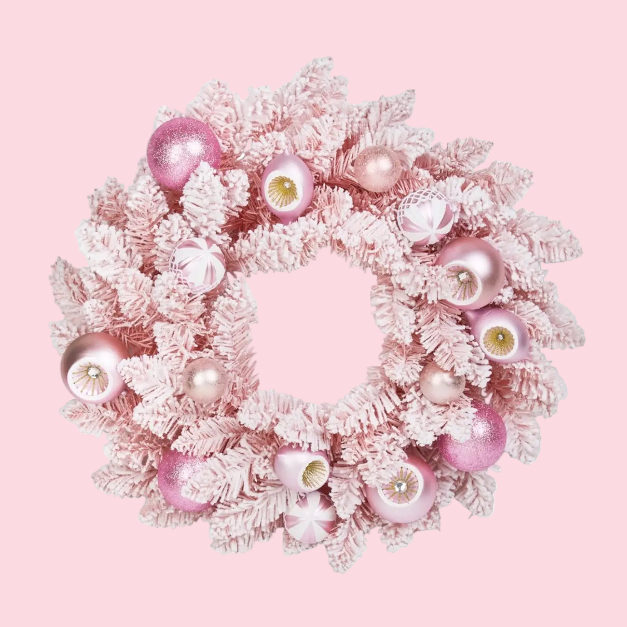 A pink flocked wreath with pink retro ornaments. 