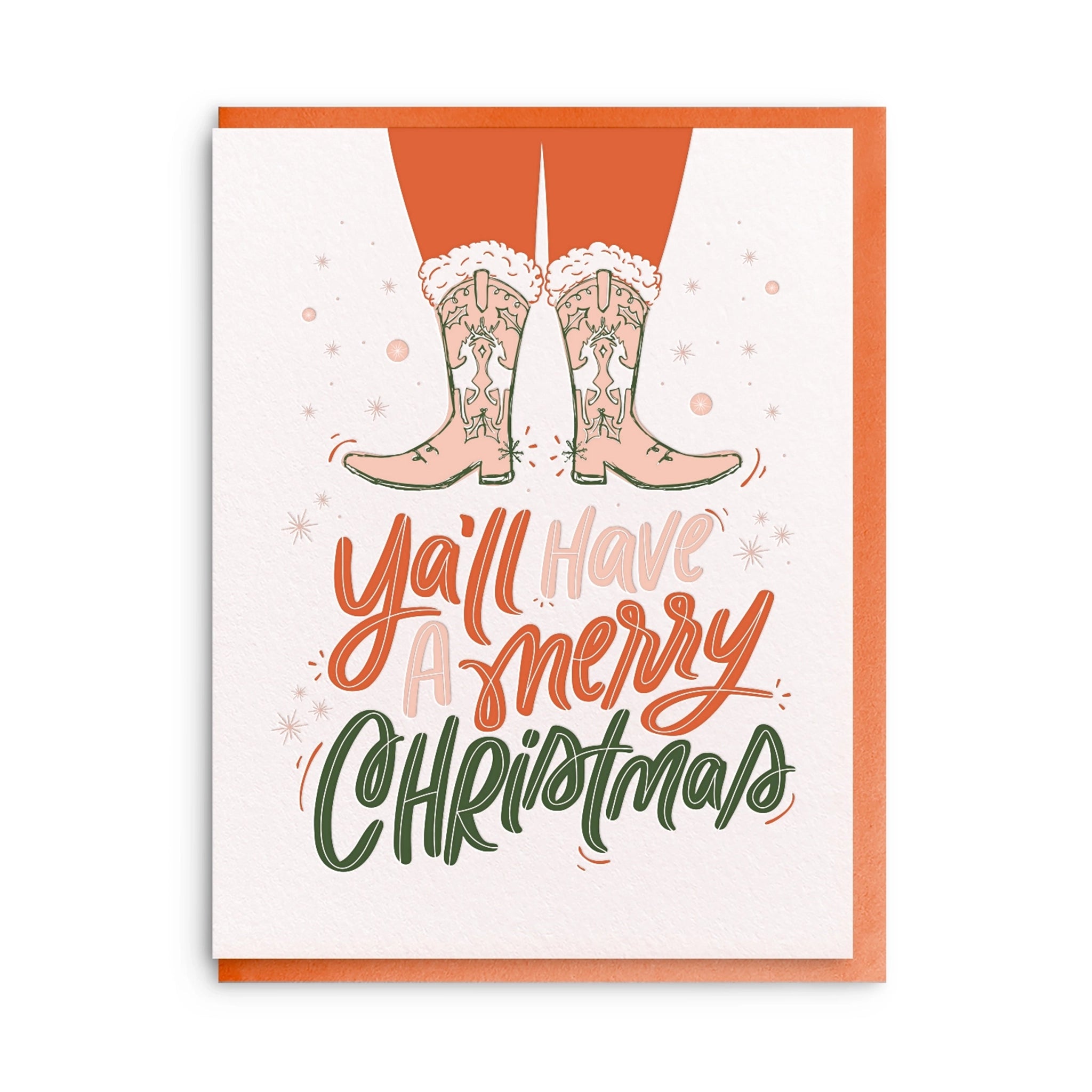 On a white background is a white card with red, pink and green text that reads, &quot;Ya&#39;ll have a merry christmas&quot; along with an illustration of two legs with western boots on with designs of reindeer and holly. 