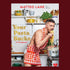 A book cover with Matteo Lane wearing a heart patterned apron and eating pasta with a title that reads, 'Your Pasta Sucks A "Cookbook"'. 