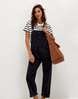 A black pair of denim overalls.