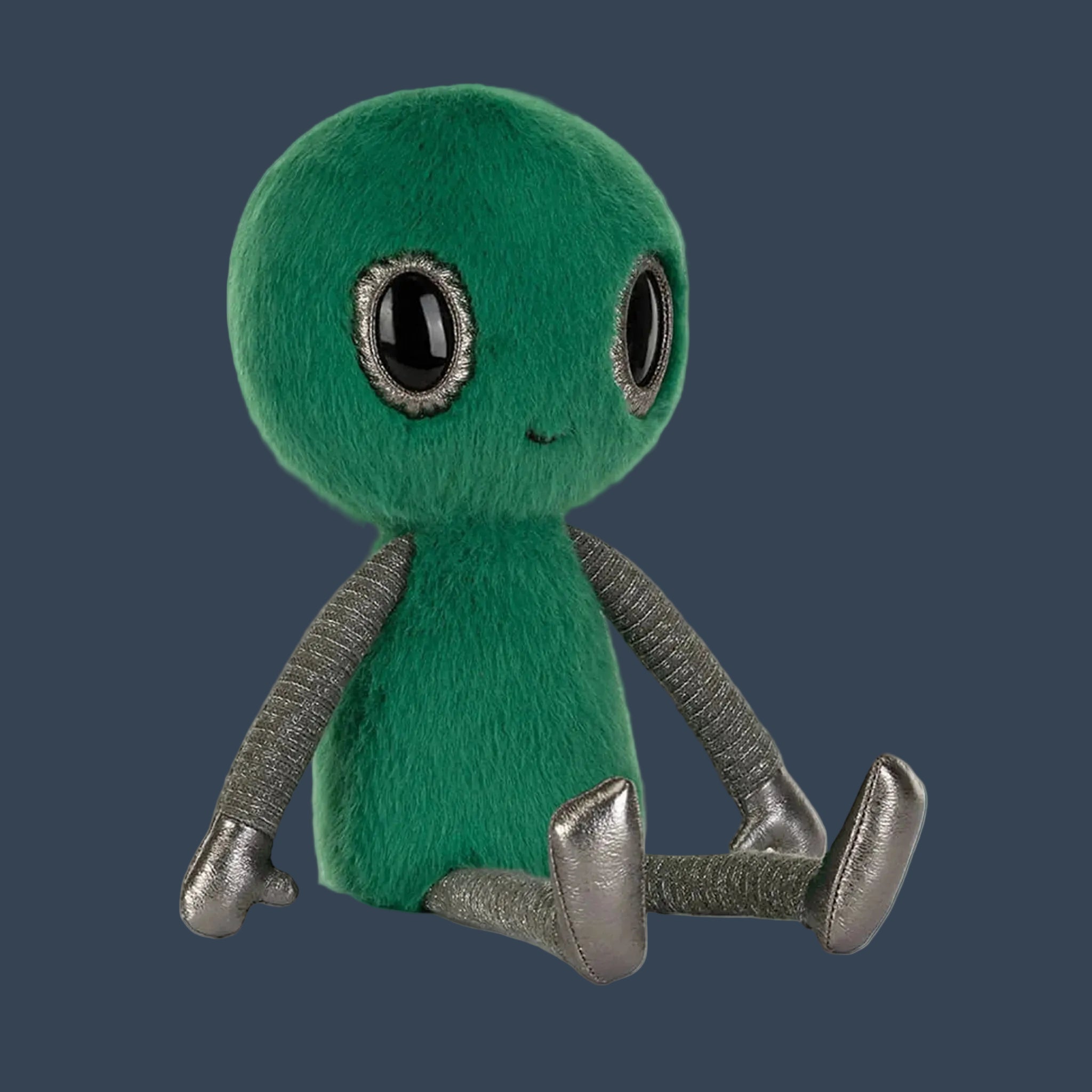 A green fuzzy alien shaped stuffed toy. 