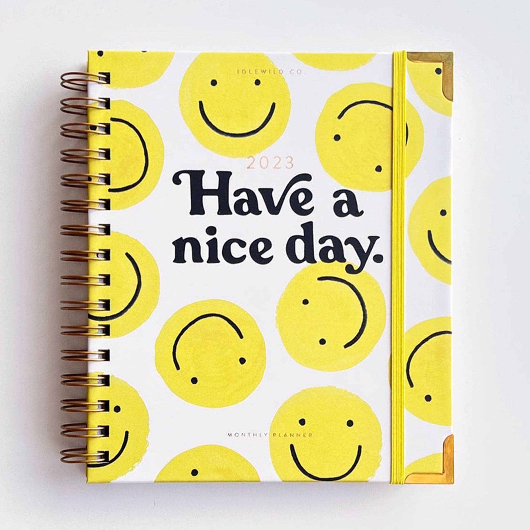 a 2023 planner with yellow smiley face doodles all over.