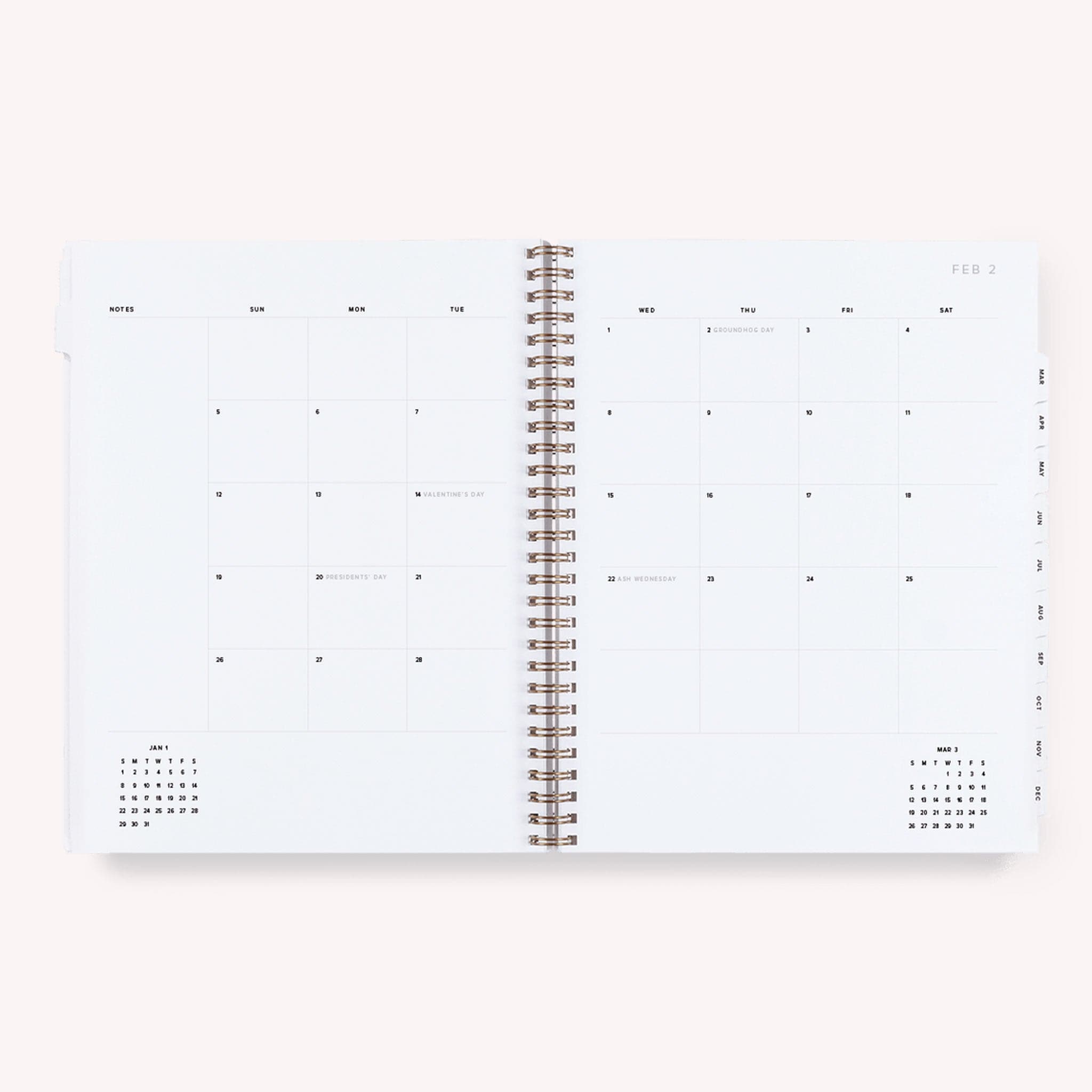 A lavender yearly planner that&#39;s gold spiral bound. The inside features daily to-do&#39;s, a notes page at the end of each month and a monthly view as wel