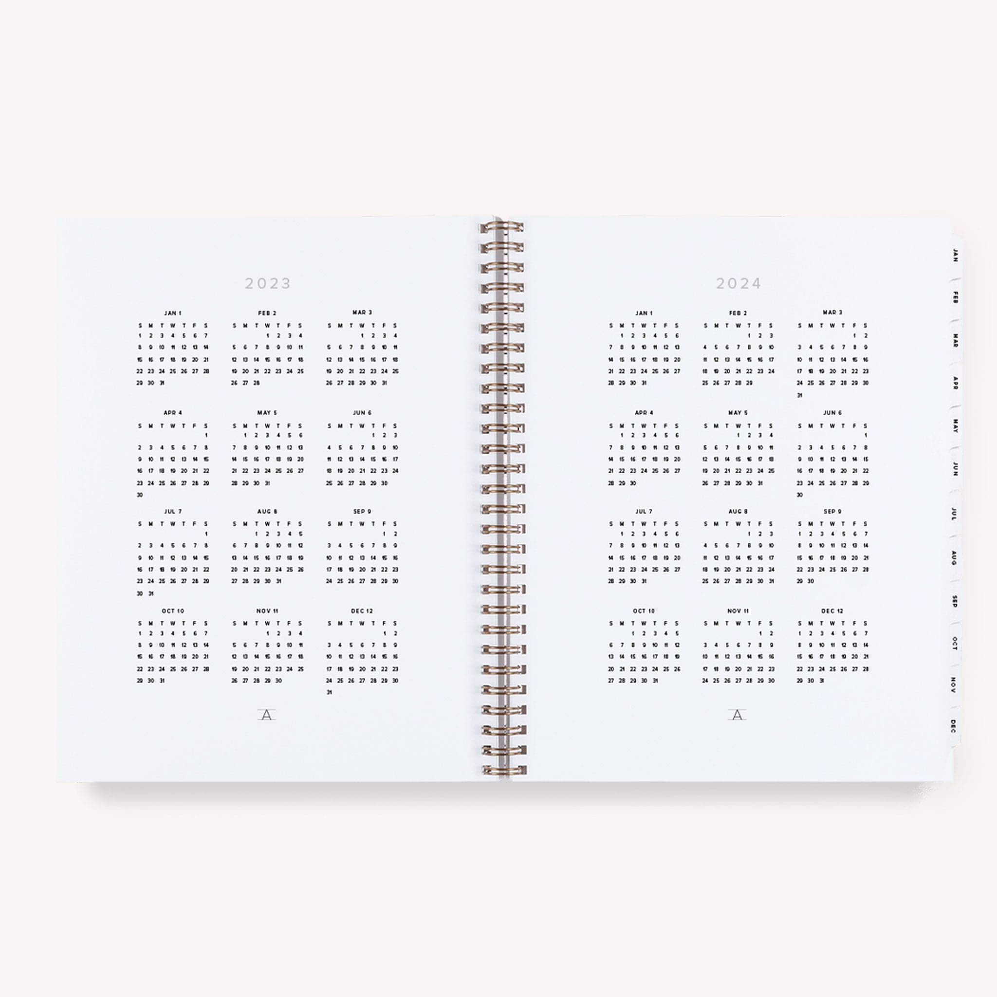 A lavender yearly planner that&#39;s gold spiral bound. The inside features daily to-do&#39;s, a notes page at the end of each month and a monthly view as wel