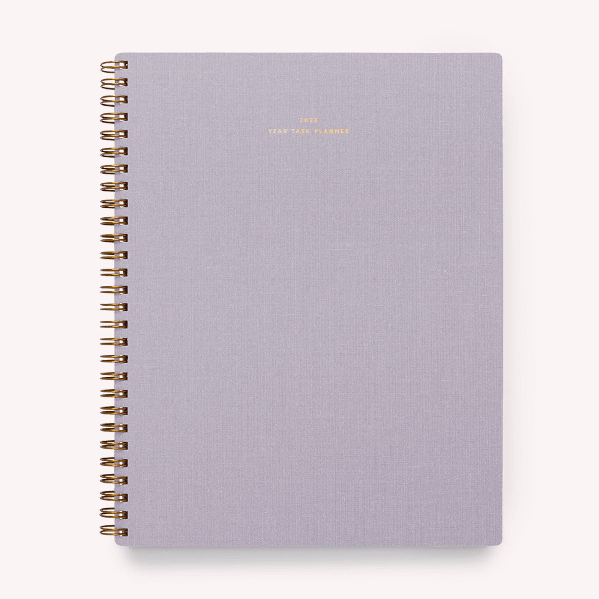 A lavender yearly planner that&#39;s gold spiral bound.