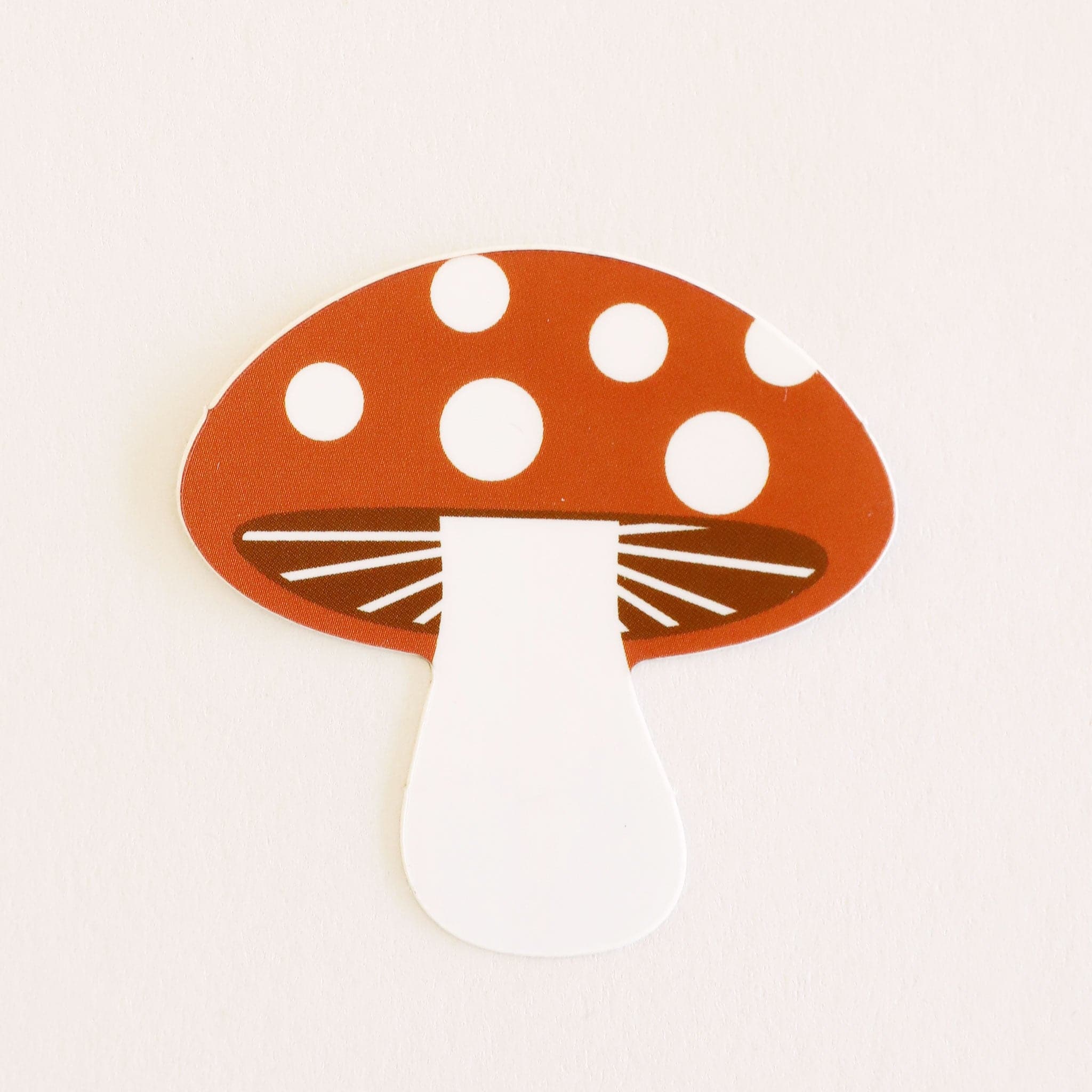 Classic mushroom sticker with spotted red top and white stem.