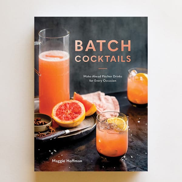 Cocktail book titled "Batch Cocktails. Make-Ahead Pitcher Drinks for Every Occasion. Maggie Hoffman." The cover image shows a tray with a pitcher of tangerine liquid, a sliced blood orange, and a knife. Two tangerine colored cocktails with lemon garnishes sit beside the tray.