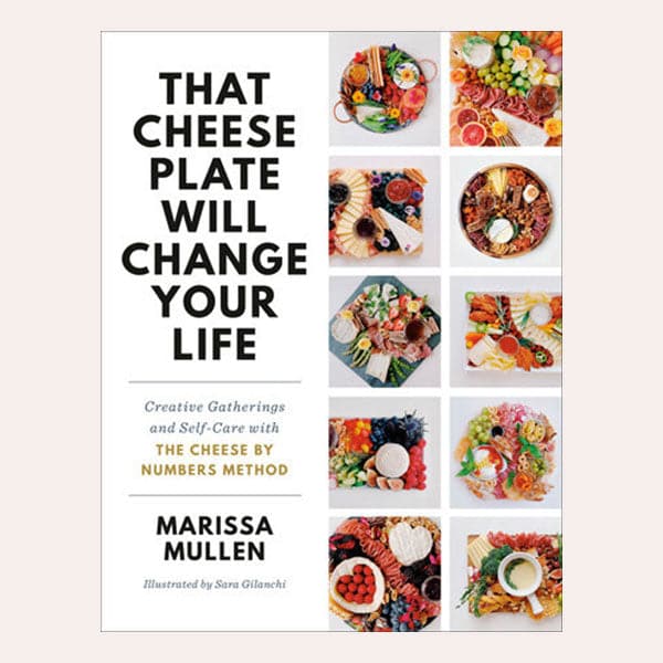 The front cover of the book reads &#39;That Cheese Plate Will Change Your Life&#39; in bold black lettering on the left side. Below reads &#39;Creative Gathering and Self-Care with The Cheese by Numbers Method&#39; in smaller text. To the right is 10 squares filled with a variety of well put together charcuterie boards, filled with cheeses, crackers, jams and more.  