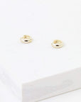 Small huggie style gold hoop earrings.