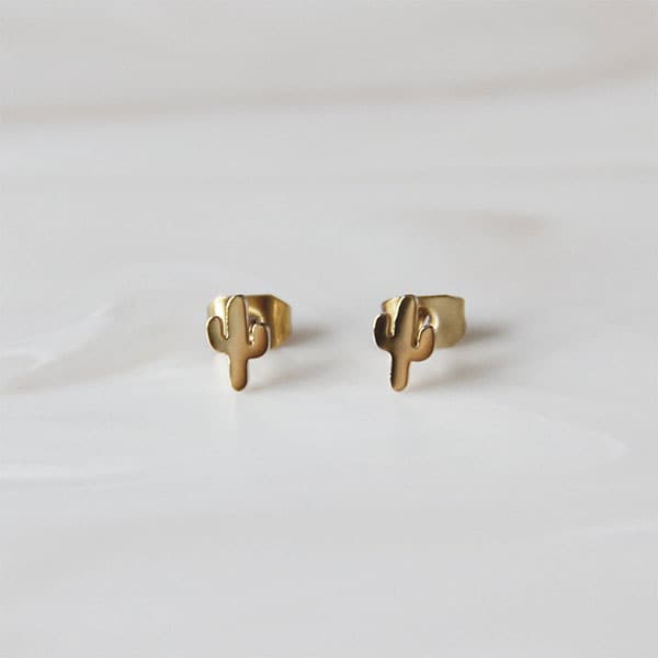 Dainty gold cactus stud earrings with a straight post and gold backing.