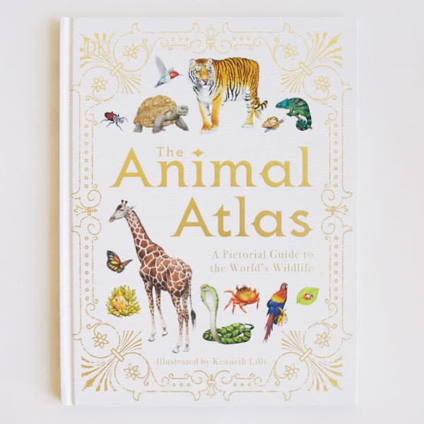 The front cover of the book reads 'The Animal Atlas': A pictorial Guide to the World's Wildlife' in gold lettering. The text is surround by a variety of animals including tigers, turtles, giraffes, and more. The cover of the book is bordered with elegant gold detailing.