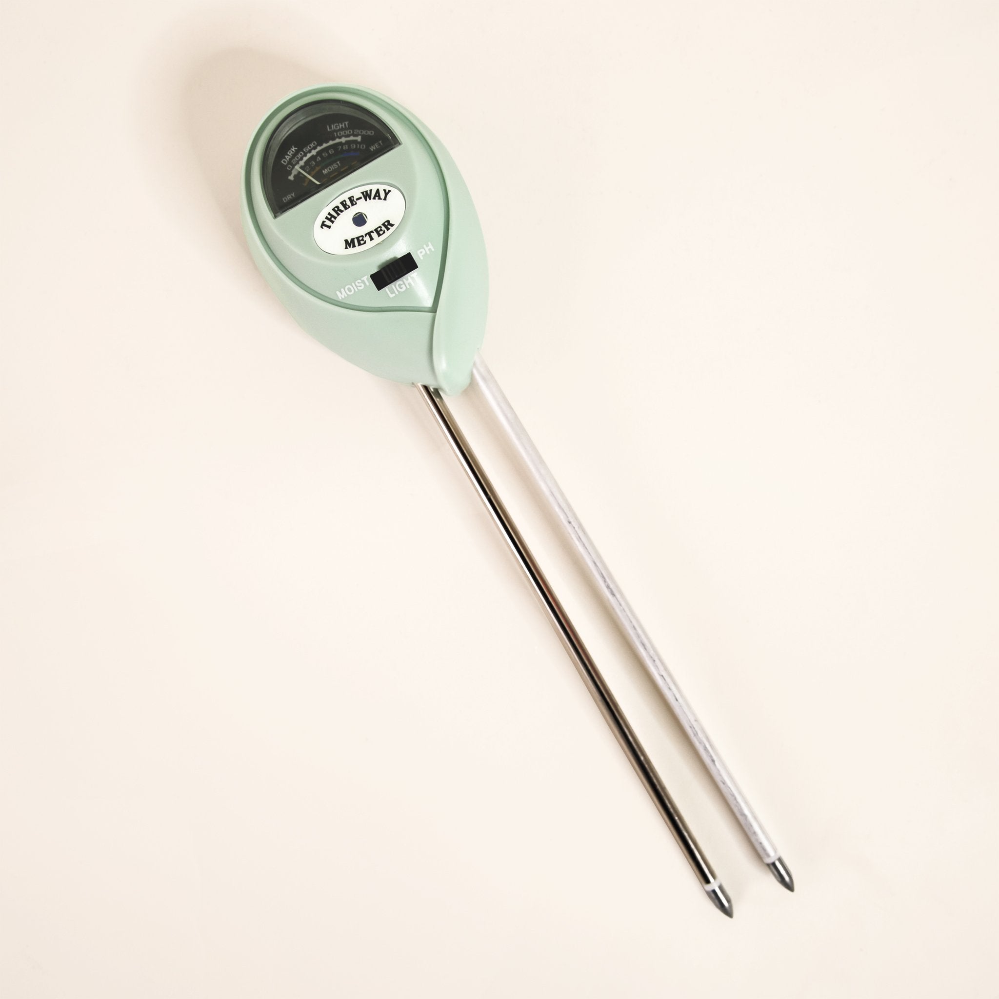 A light blue moisture meter with a circular head and a meter with a black background and text in the center that reads, &quot;Three-way Meter&quot; in black writing along with two long metal points that are meant to go into your plant&#39;s soil to determine the moisture levels.