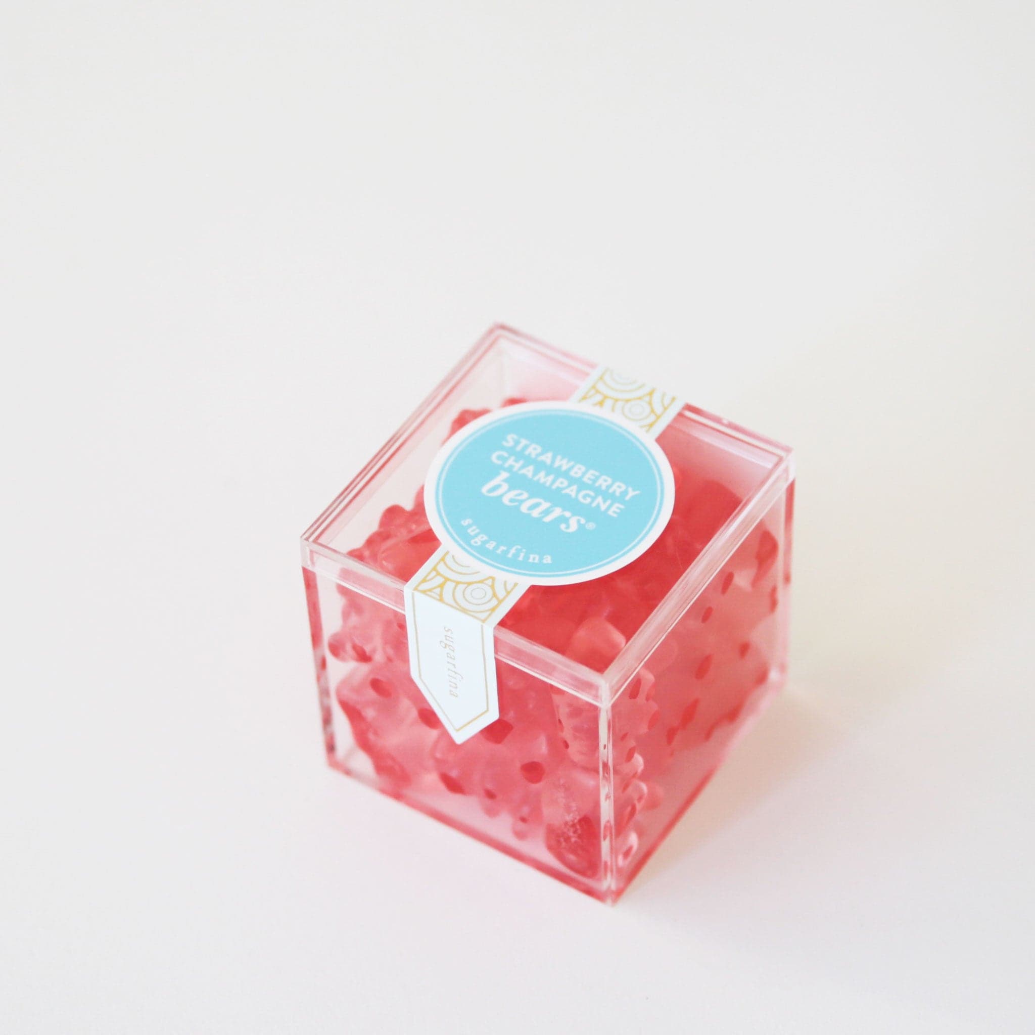 Strawberry champagne gummy bears packaged in an acrylic box.
