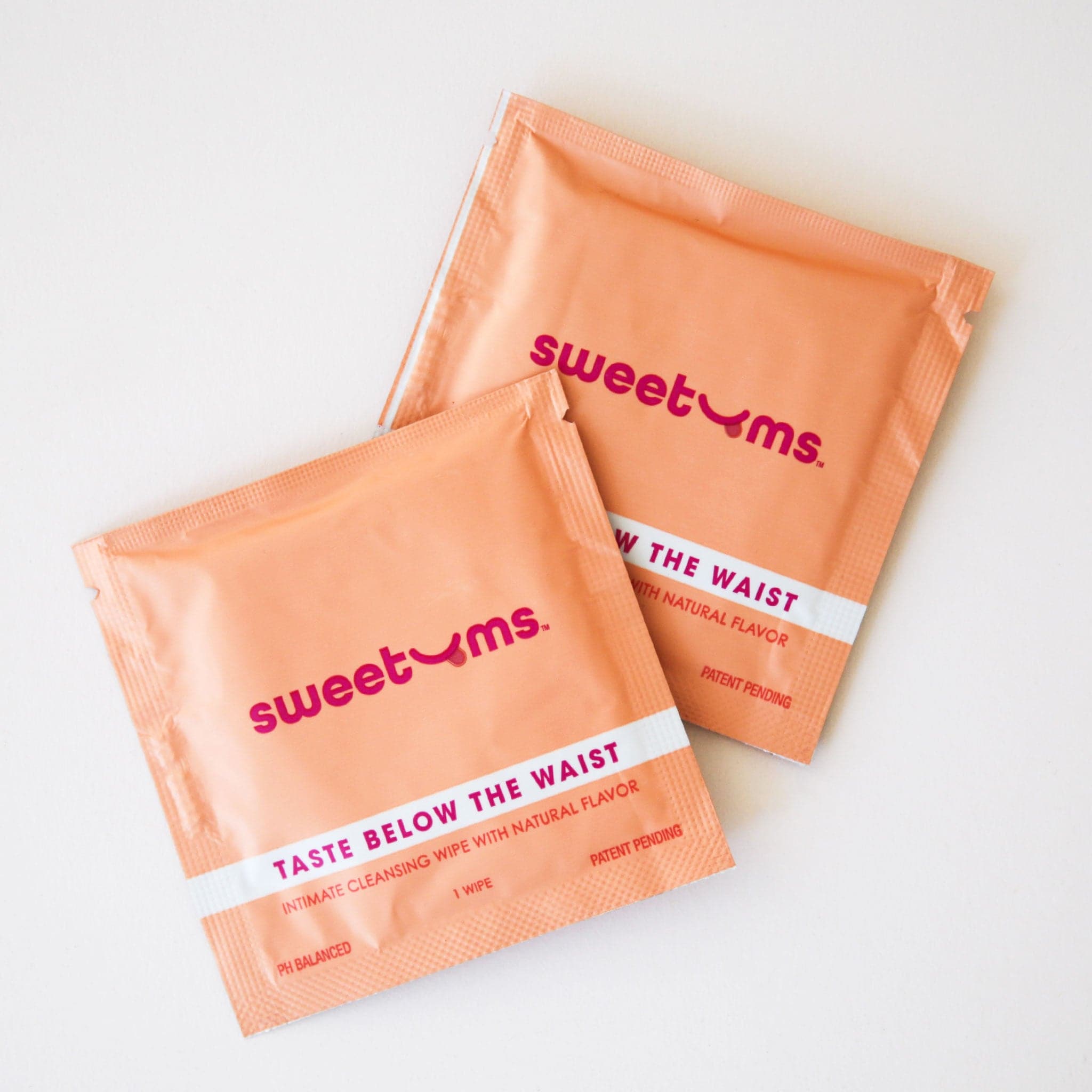 Individual packets of intimate cleaning wipes. Each scent has a different color packaging, and this mango flavor is orange.