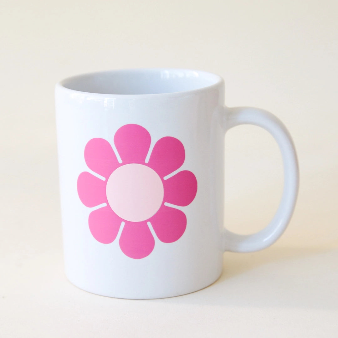 A white ceramic mug with &quot;Best Mom Ever&quot; in pink 70&#39;s style bubble writing along with a pink daisy on the back side.  Edit alt text