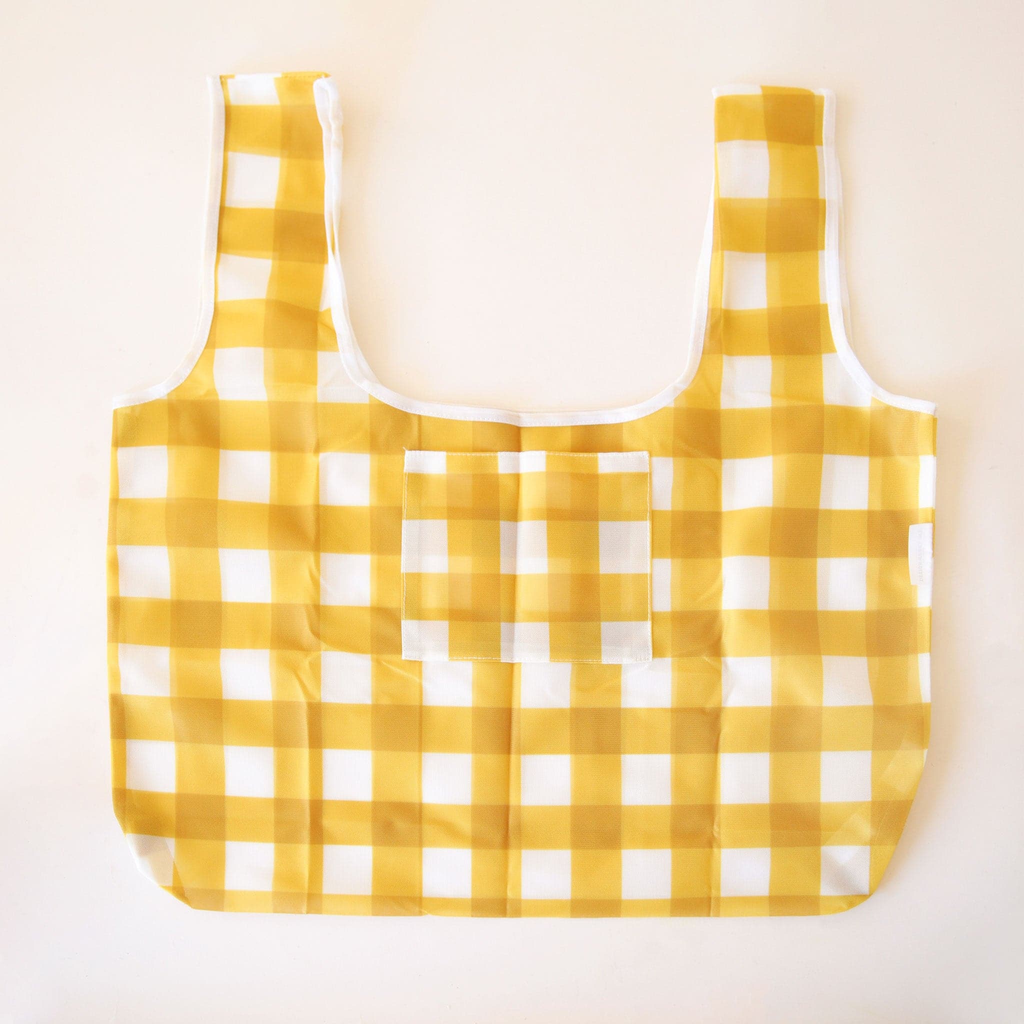 A yellow gingham nylon bag with two straps and a small pocket for keys or any other easy-to-grab essentials.