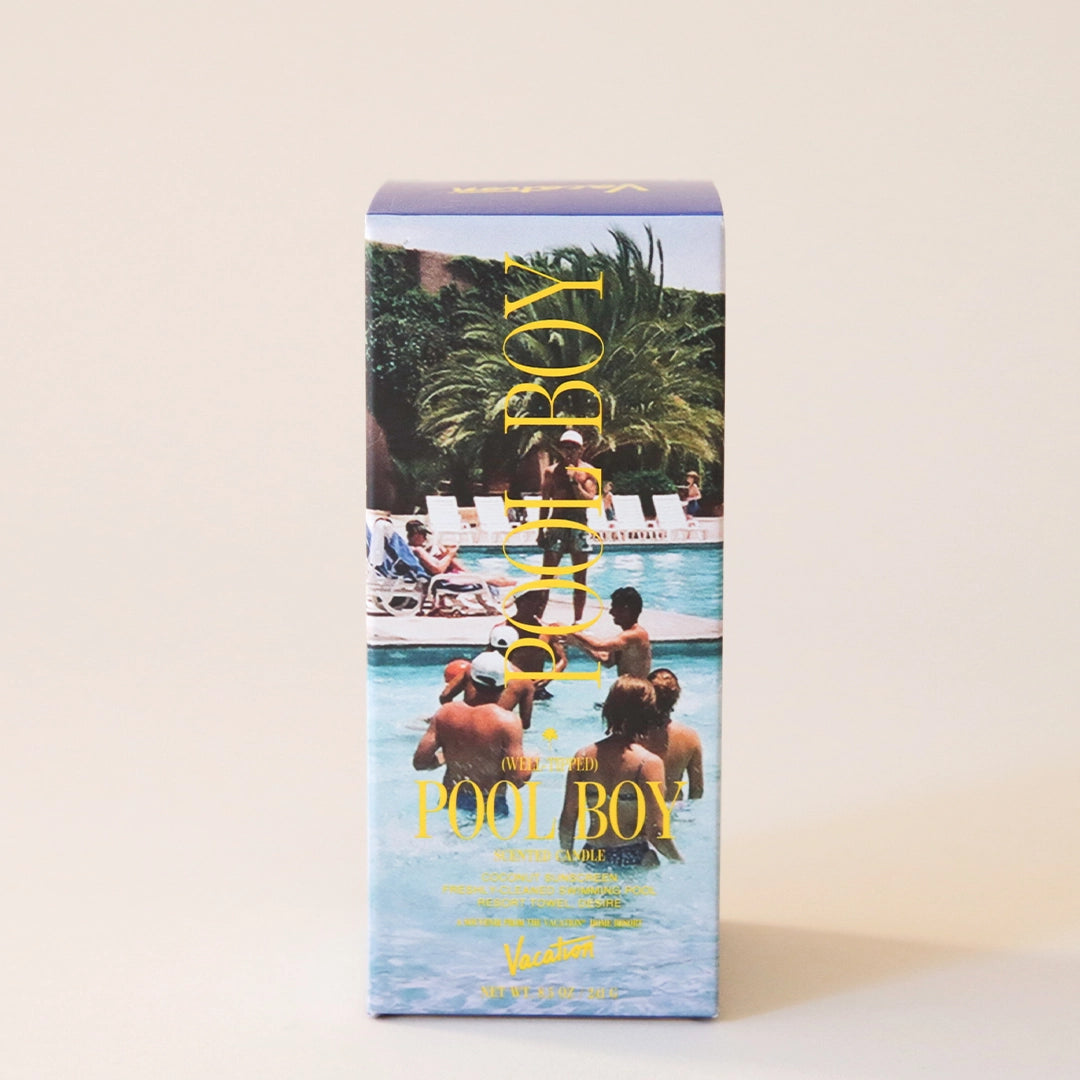 The exterior of the candle packaging that features an all over pool print with people swimming along with text that reads, "Pool Boy" in yellow text.