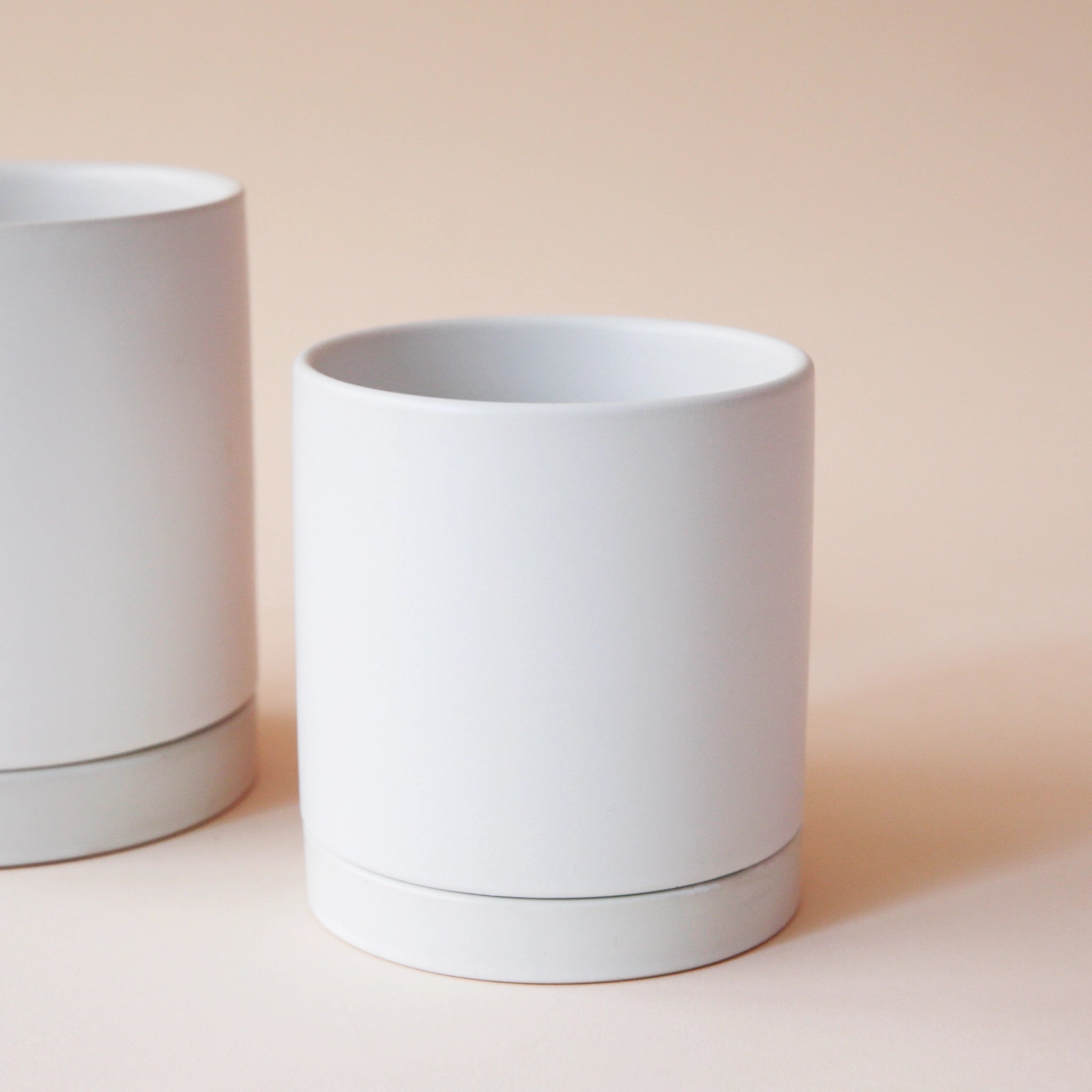 simple white cylindrical pot with matching saucer