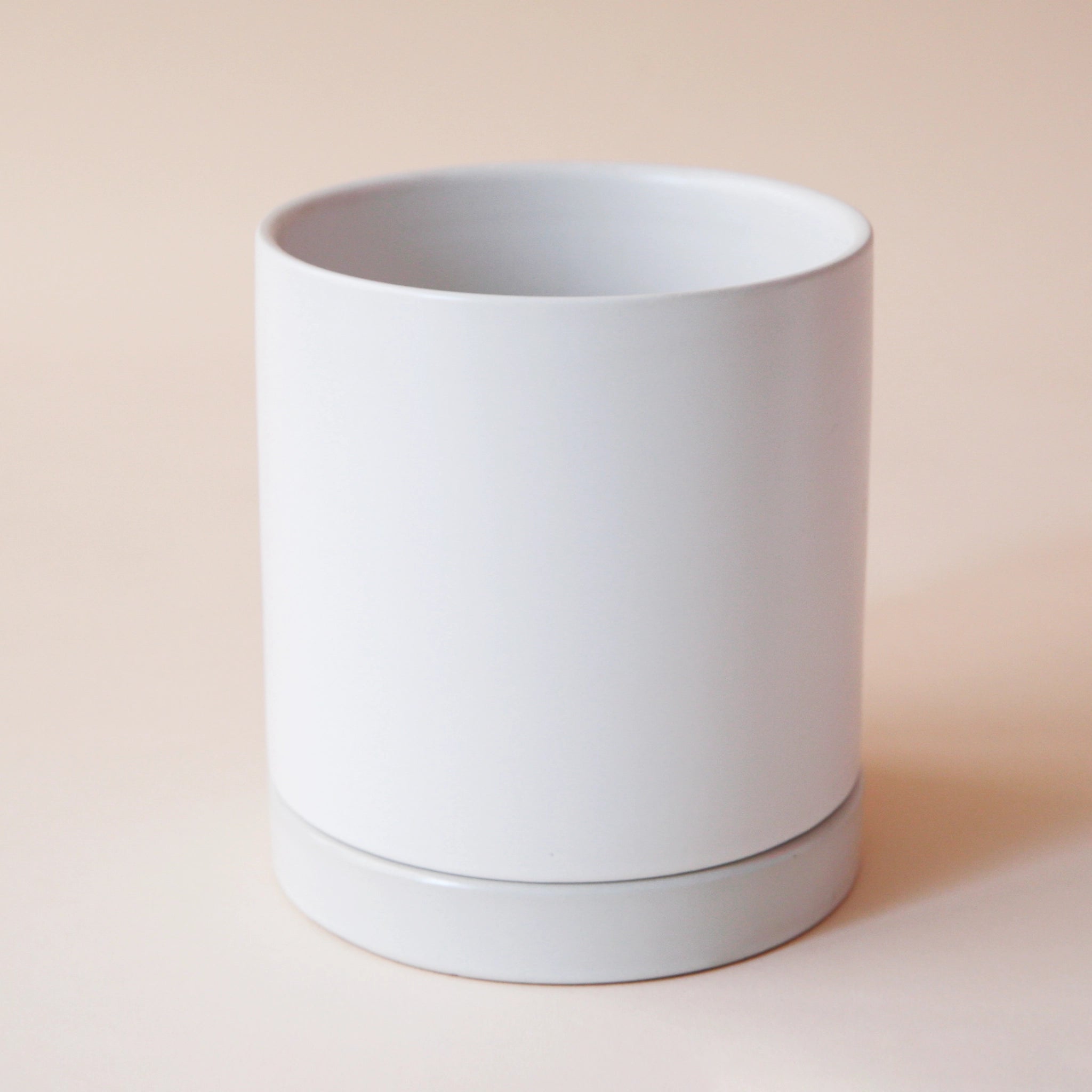 simple white cylindrical pot with matching saucer