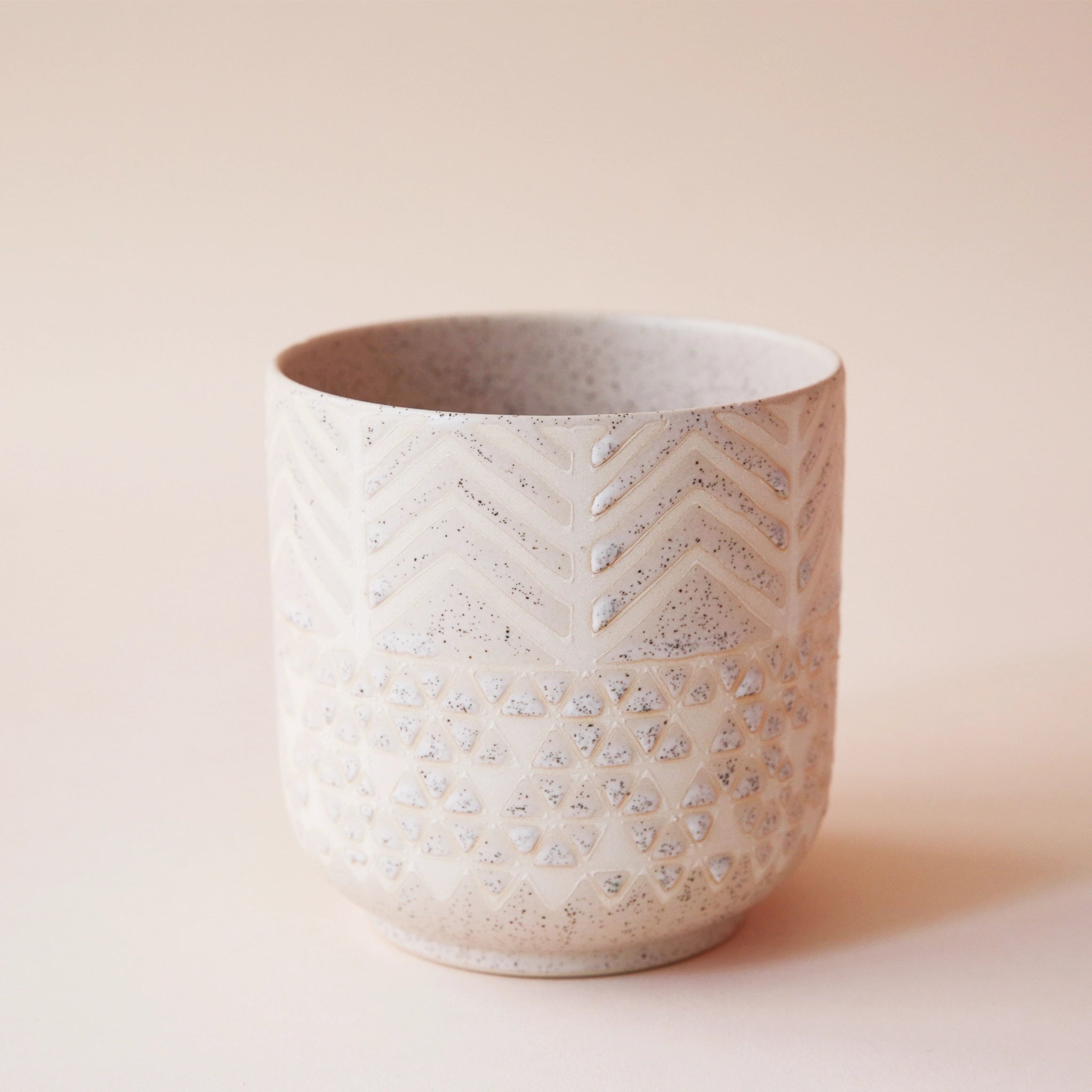 cream colored pot with chevron detail and speckles
