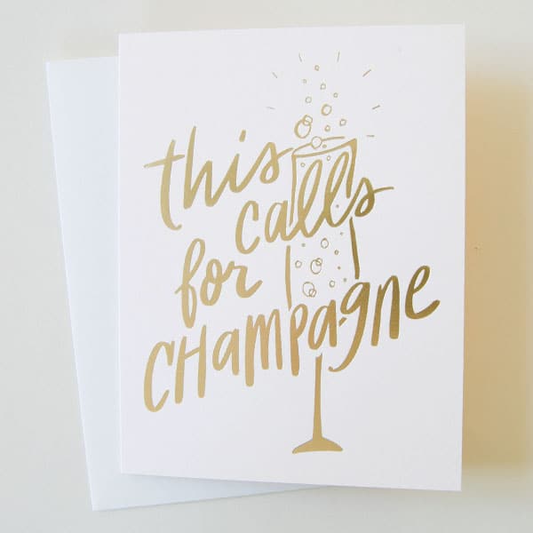 This celebratory card reads &#39;this calls for champagne&#39; across a glass of bubbly in gold foil print. This card is a soft ivory and accompanied by a white envelope. 