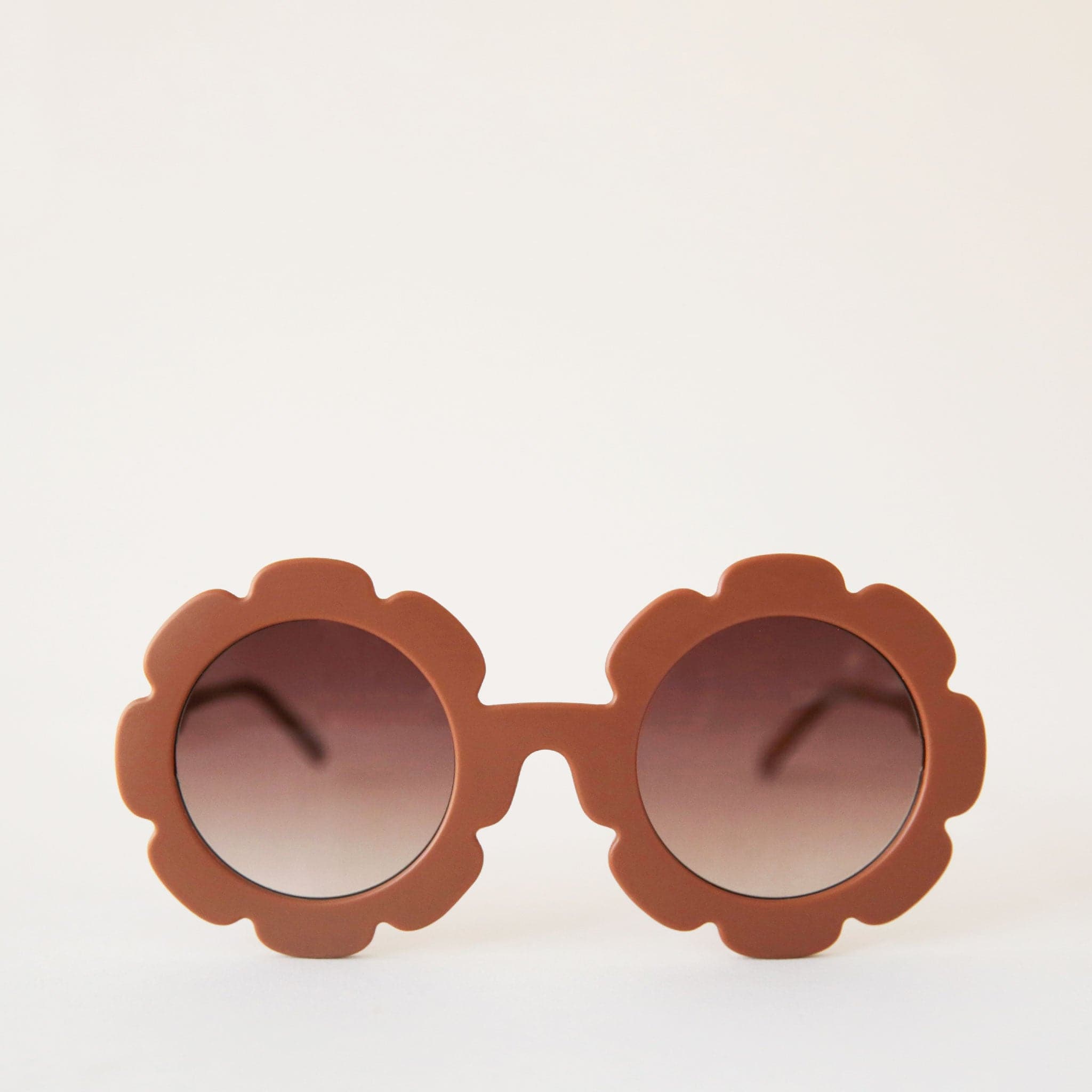 Brown flower shaped sunglasses with light brown circle lenses in the center.