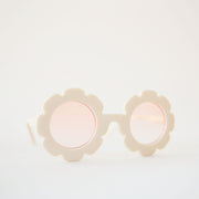 White flower sunglasses with a pink lens.