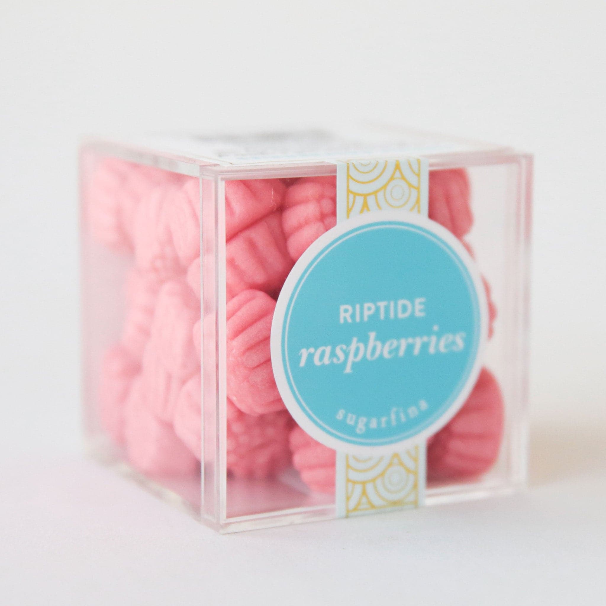 A clear acrylic packaging with pink raspberry shaped gummies.