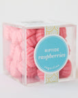 A clear acrylic packaging with pink raspberry shaped gummies.