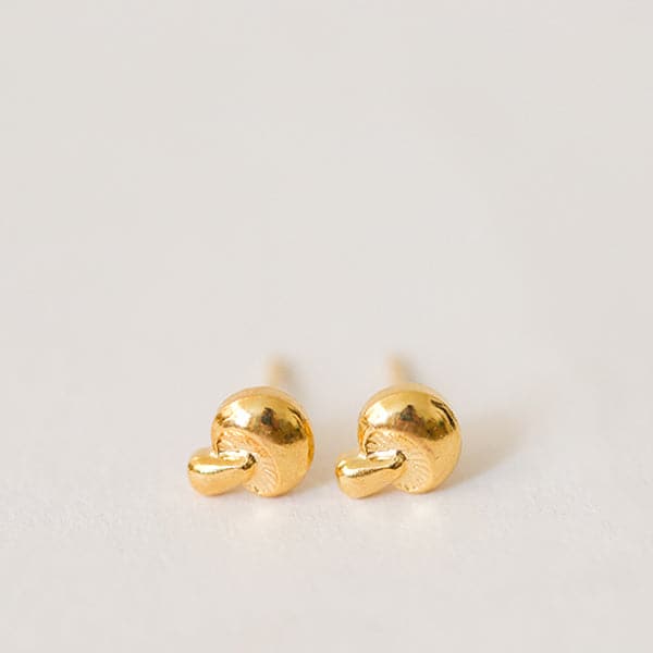 Small gold mushroom shaped stud earrings.