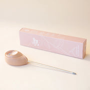 A pink moisture meter with a rounded head and a white meter that ranges from dry, moist, or wet along with a small oval label in the front that reads, "Jungle Club".