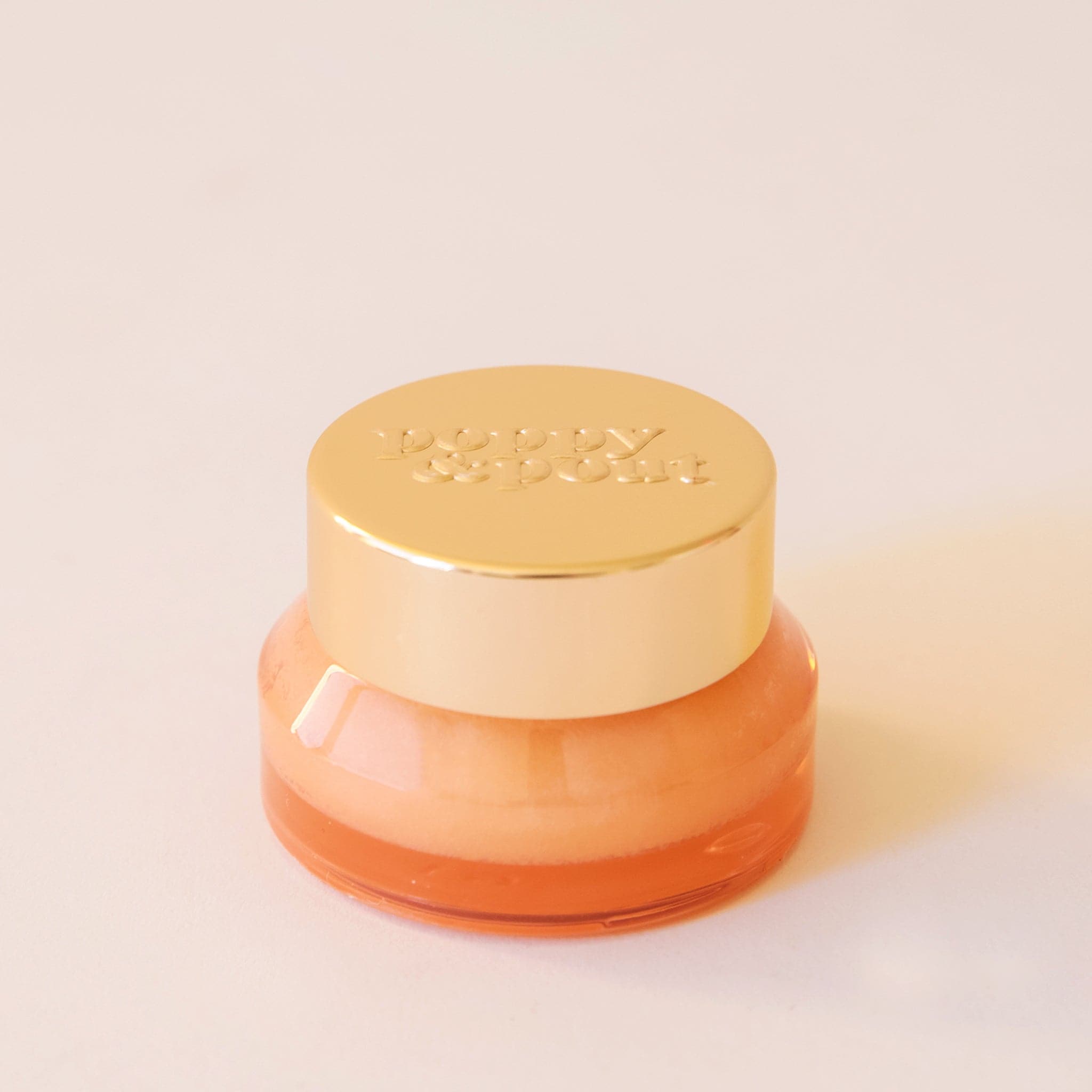Lip scrub in an honeydew colored container with a gold lid. This lip scrub is grainy, hydrating and perfect for your lips.