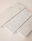 A white, rectangular marble tray in three different sizes. Each tray sold separately.