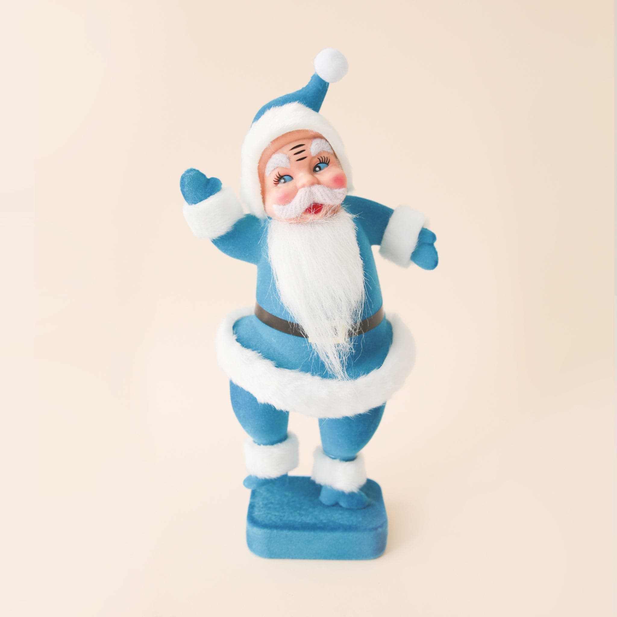 A blue Santa Christmas decoration with blue velvet suit on.