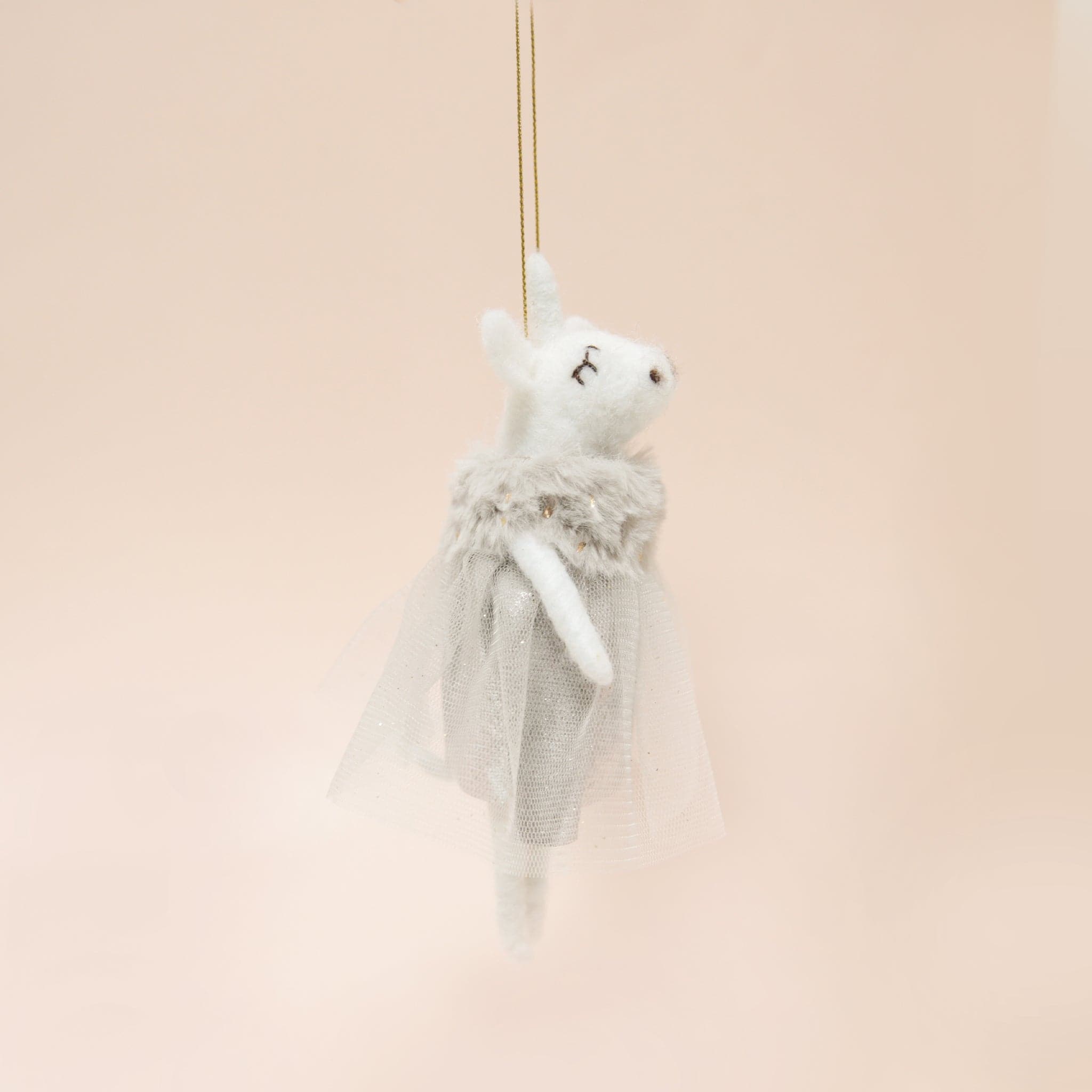A white felt unicorn ornament with a grey tulle dress.