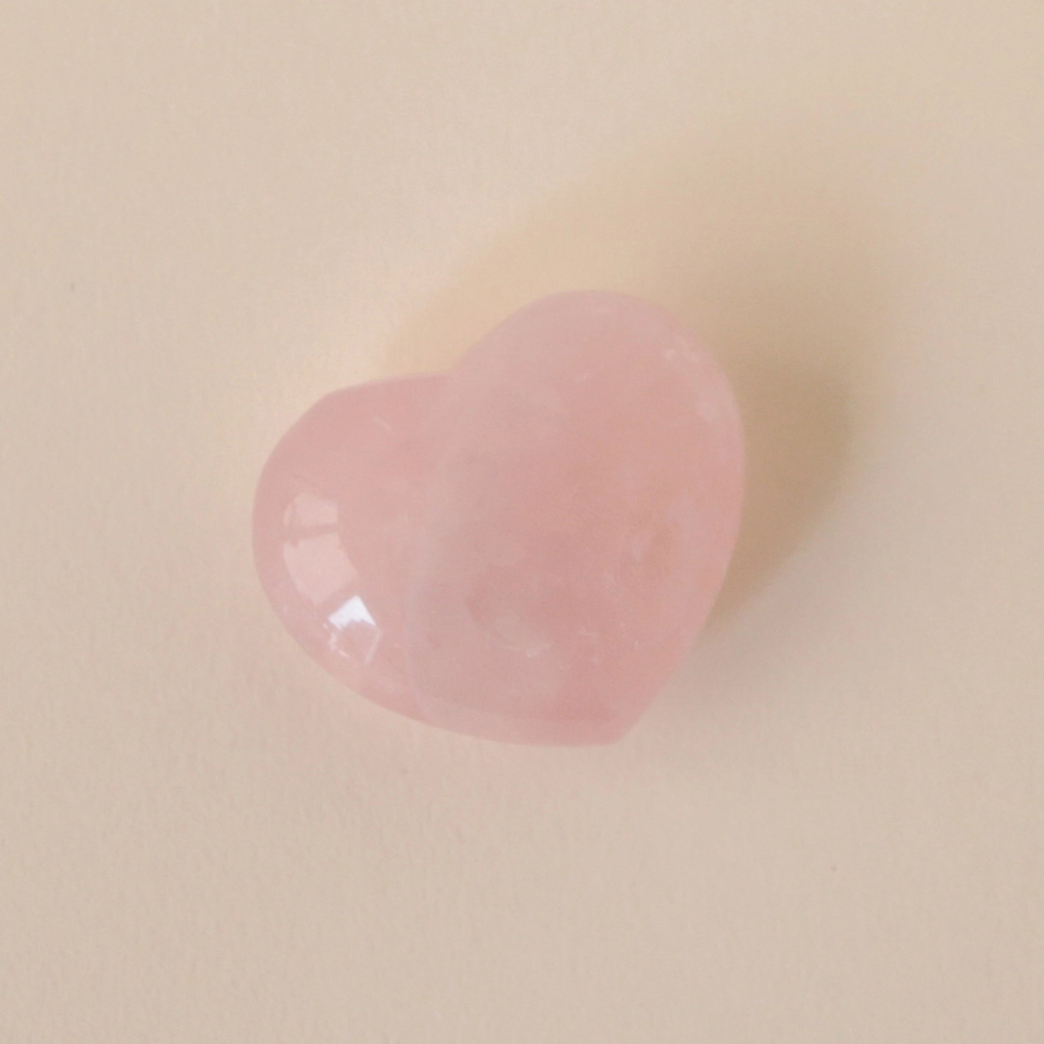 A heart shaped rose quartz crystal.